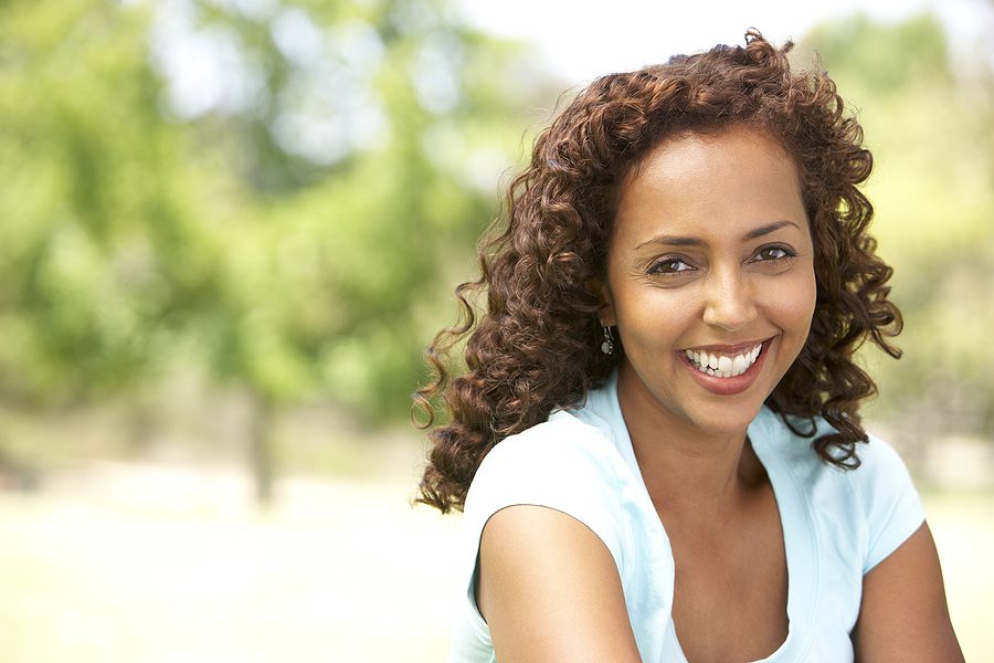 Smiling woman at a park.