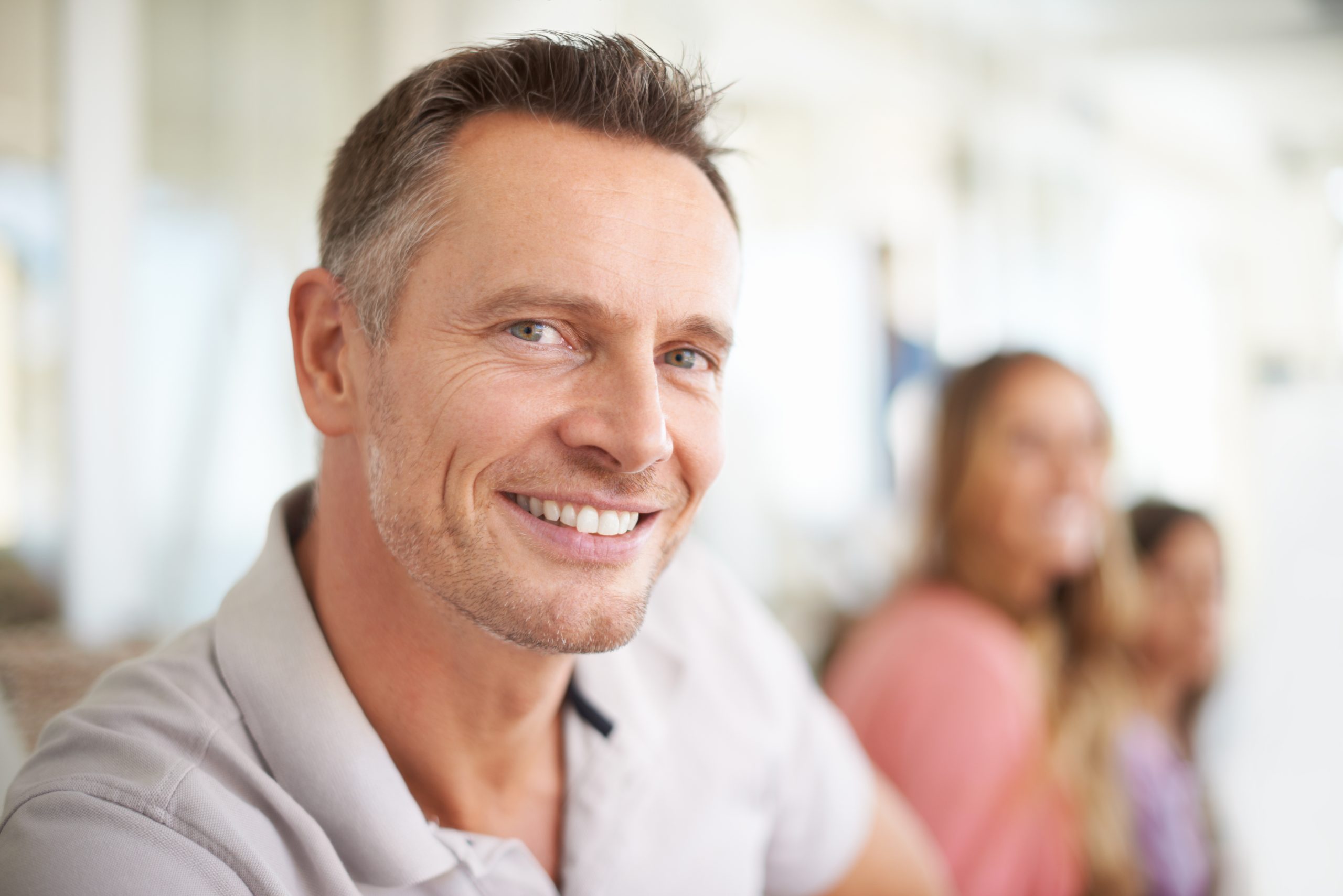 mature man smiles for the camera after having all on 4 dental implant surgery