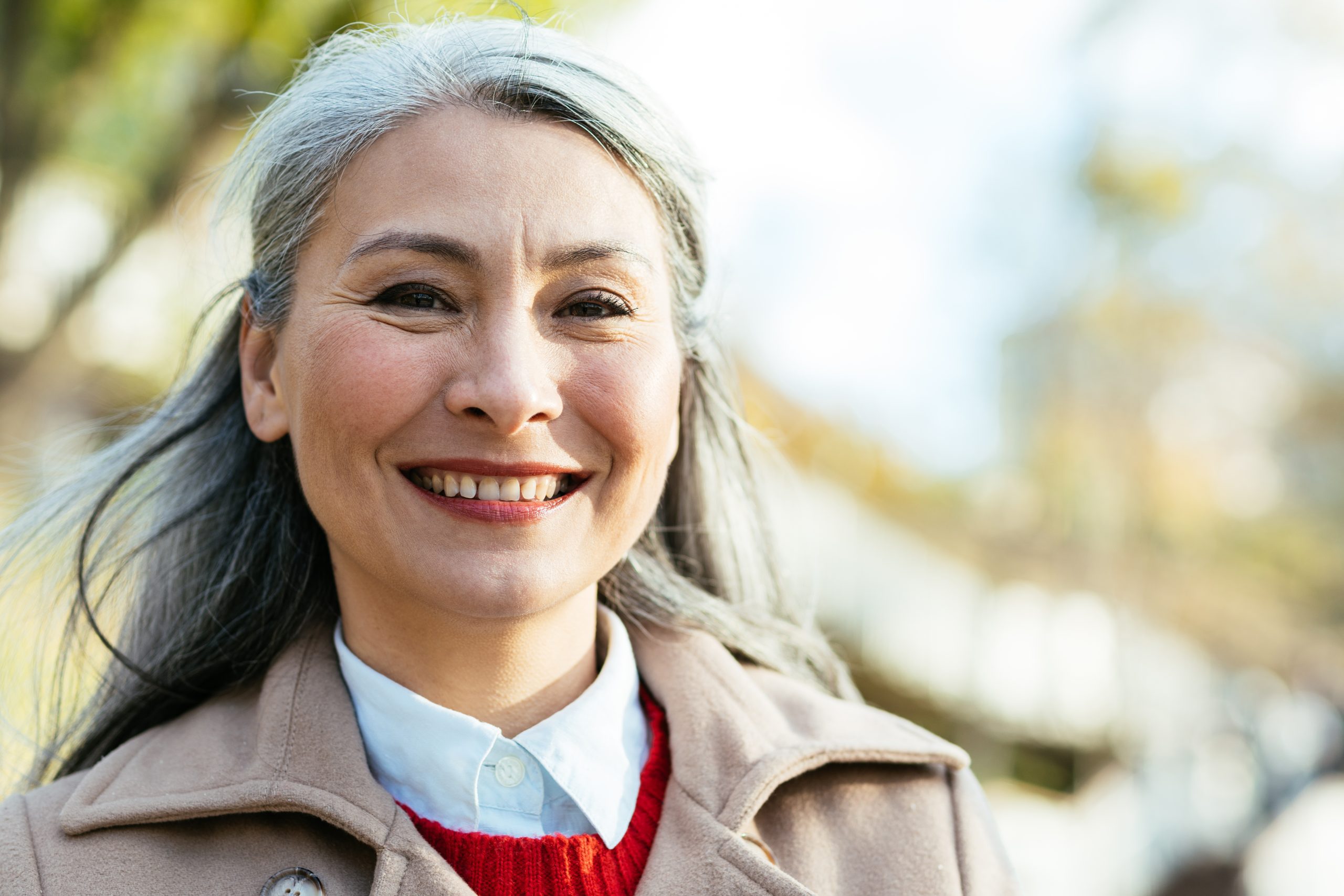 Smiling woman who is happy after her completing all on 4 dental implants